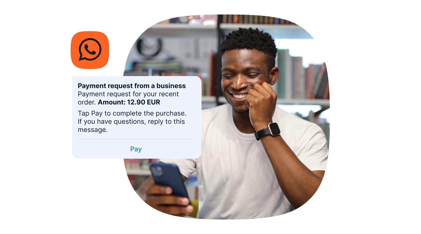 Man smiling at his phone while viewing a WhatsApp payment request message for 12.90 EUR, with an orange WhatsApp icon beside the message.