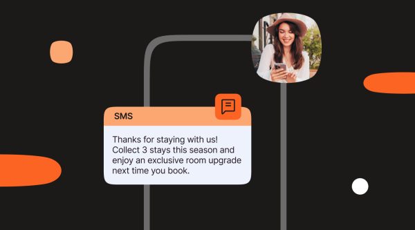 Strategies and examples for SMS loyalty programs, featuring a message offering a room upgrade after three stays and a smiling woman engaging with her phone, showing how SMS loyalty programs can boost customer retention and reward loyalty.