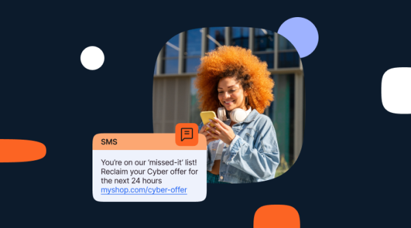 Graphic with dark blue background featuring a circular cutout of a woman with curly hair smiling at her yellow smartphone, with white headphones around her neck. Below her is an SMS message mockup that reads: “You’re on our ‘missed-it’ list! Reclaim your Cyber offer for the next 24 hours” with a link to “myshop.com/cyber-offer.” Rounded accent shapes in orange, white, and purple are placed across the background. All this to portray Cyber Monday SMS marketing campaign with expert tips, templates, and best practices.