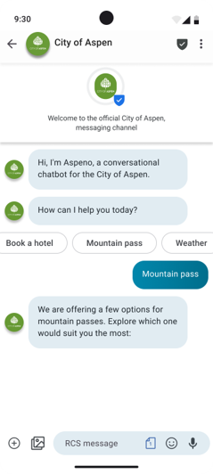 Smartphone screen showing an RCS chat with the official City of Aspen verified business account. The chatbot, named Aspen, welcomes the user and offers several quick reply button: “Book a hotel,” “Mountain pass,” and “Weather.” The user selects “Mountain pass,” prompting the chatbot to respond with available options to explore different passes. This is an example of an RCS suggestion event, showcasing interactive buttons and a verified sender within a branded messaging experience.