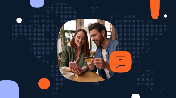 A couple sitting at a table, looking at a smartphone and holding a credit card. The image is framed by a dark background featuring a dotted world map.