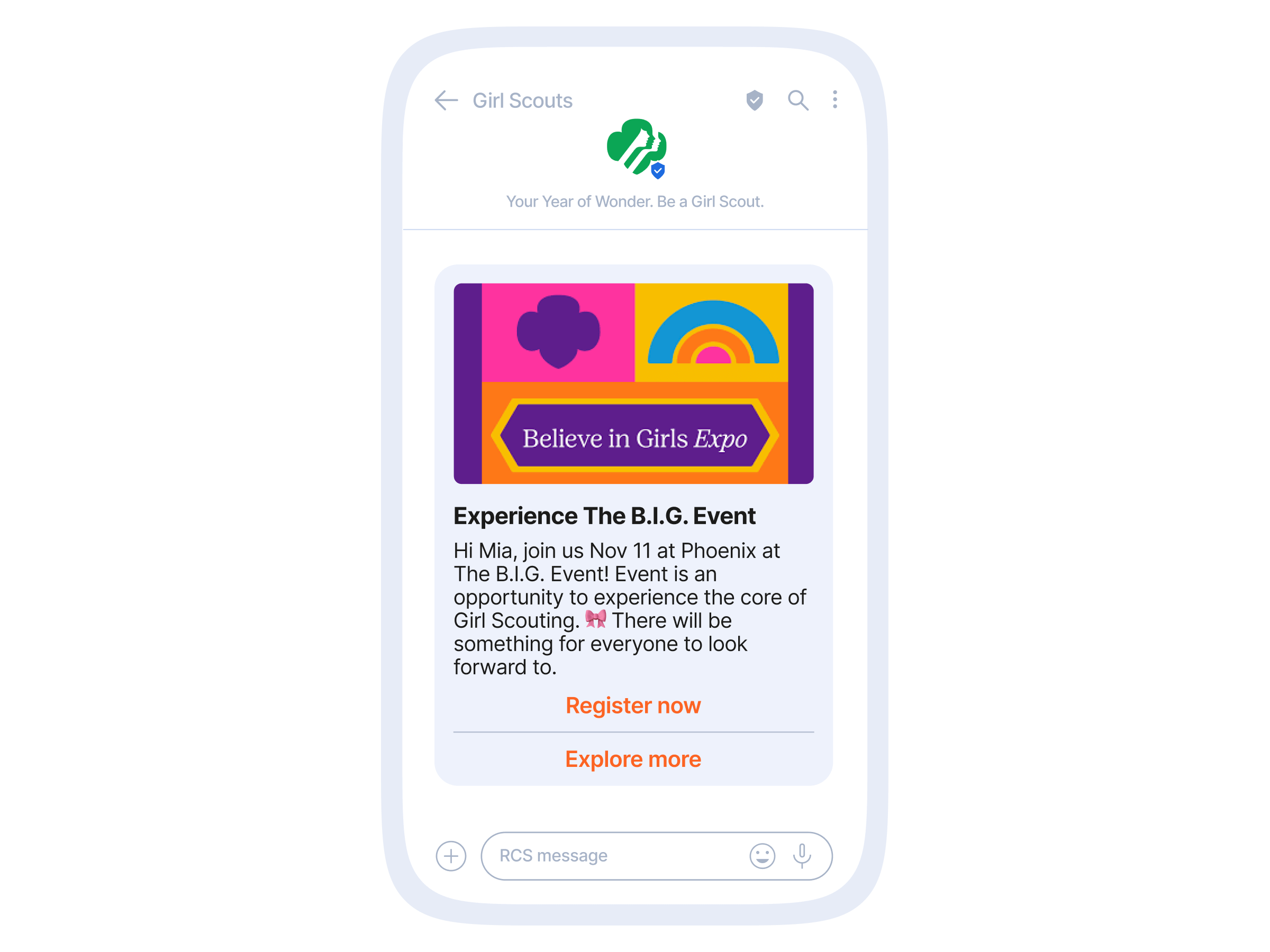 Smartphone mockup of an RCS message from "Girl Scouts" with a colorful banner reading "Believe in Girls Expo," headline "Experience The B.I.G. Event," a personalized invite to Mia for Nov 11 in Phoenix, and two orange buttons labeled "Register now" and "Explore more."