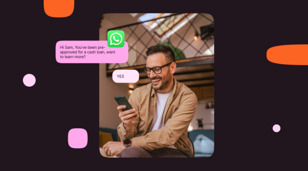 The image shows a person holding a smartphone with a WhatsApp chat overlay indicating a message that says, "Hi Sam, You’ve been pre-approved for a cash loan, want to learn more?" and a reply saying "YES." The background is dark with pink and orange abstract shapes.