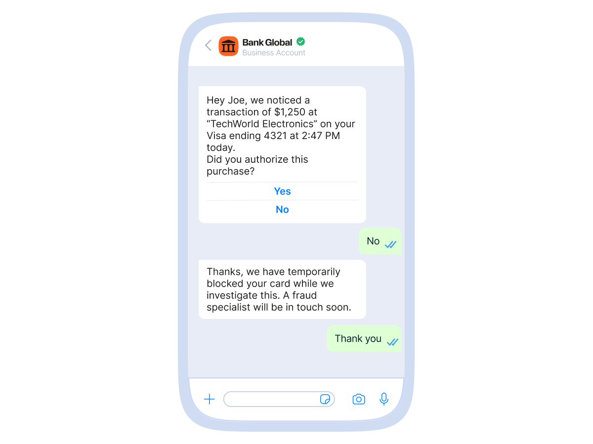 A smartphone screen showing a WhatsApp chat conversation with Bank Global. The bank alerts Joe of a $1,250 transaction at “TechWorld Electronics” on his Visa card ending in 4321 and asks if he authorized the purchase. Joe replies "No." The bank responds that the card has been temporarily blocked for investigation and that a fraud specialist will contact him soon. Joe replies with "Thank you."