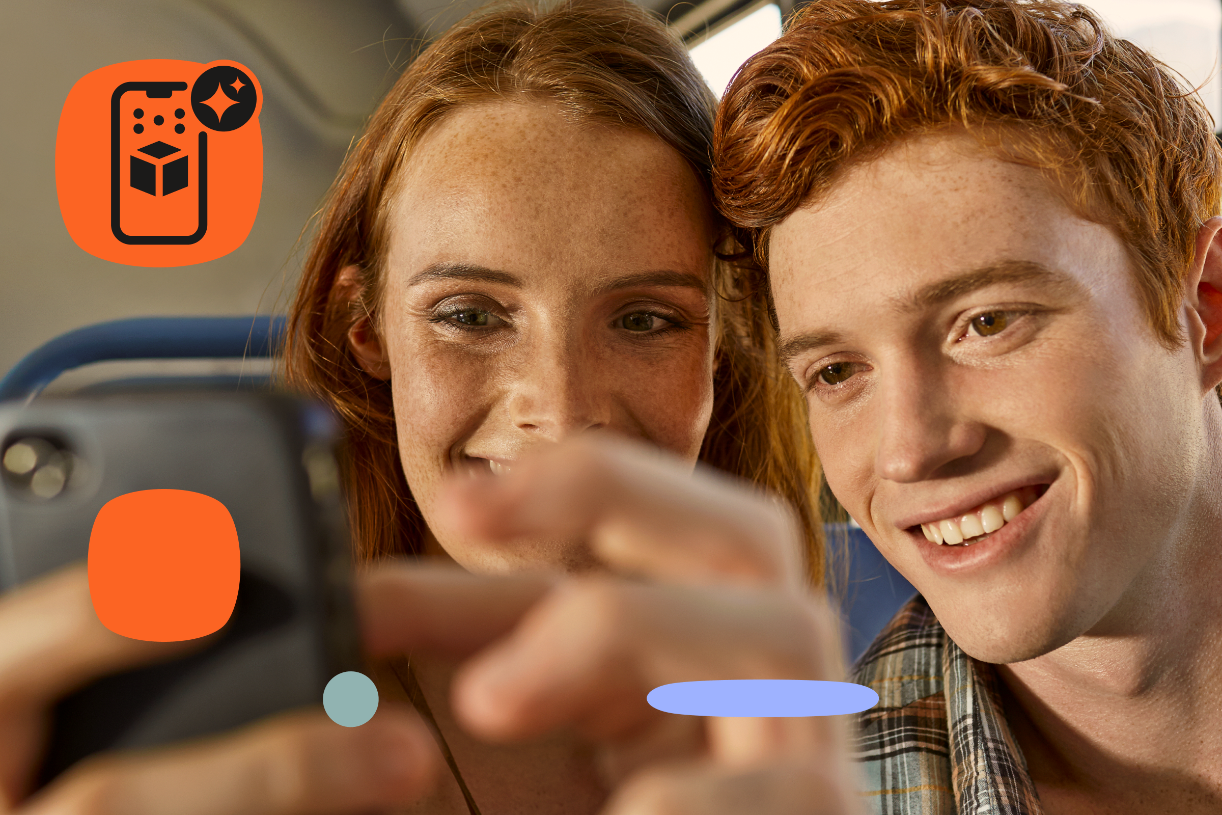 Two young adults sit close together on a bus, smiling as they look at a smartphone one of them is holding. The woman on the left has long auburn hair and freckles, while the man on the right has short reddish hair. Their hands are in front of the camera, slightly blurred as they interact with the phone. The background shows blue bus seats and soft daylight coming through the window. Orange and pastel graphic shapes and an AR-themed smartphone icon are overlaid around the photo.