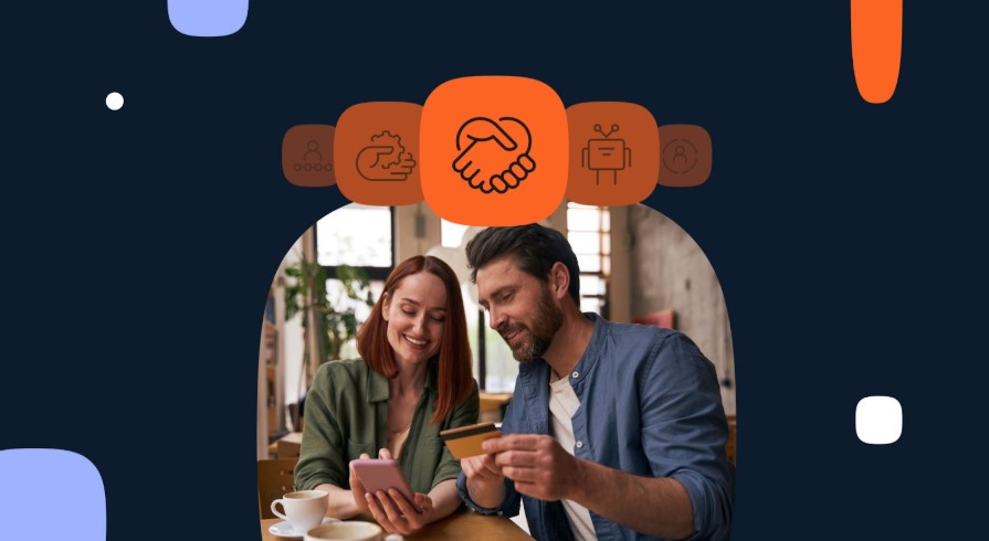 Mujer con teléfono en las manos y hombre con una tarjeta de crédito.