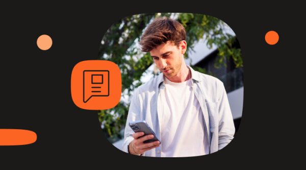 A visual intro into the How to change RCS number blog. Person standing outdoors, holding a smartphone and looking at the screen, with trees and sunlight in the background. An orange icon with a document symbol is placed to the left.