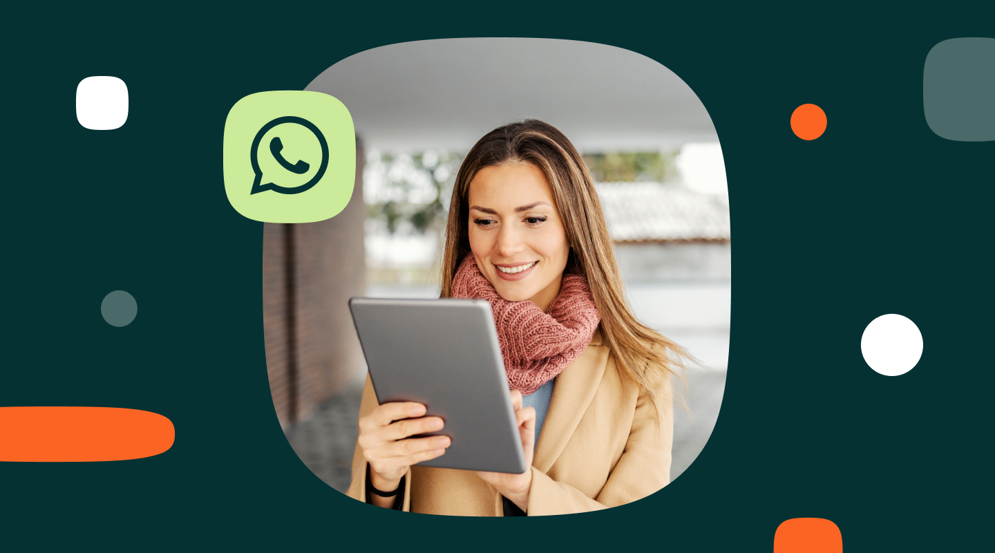 Smiling woman wearing a coat and scarf, standing outdoors and using a tablet, with a WhatsApp logo icon in a stylized frame on a dark green background.