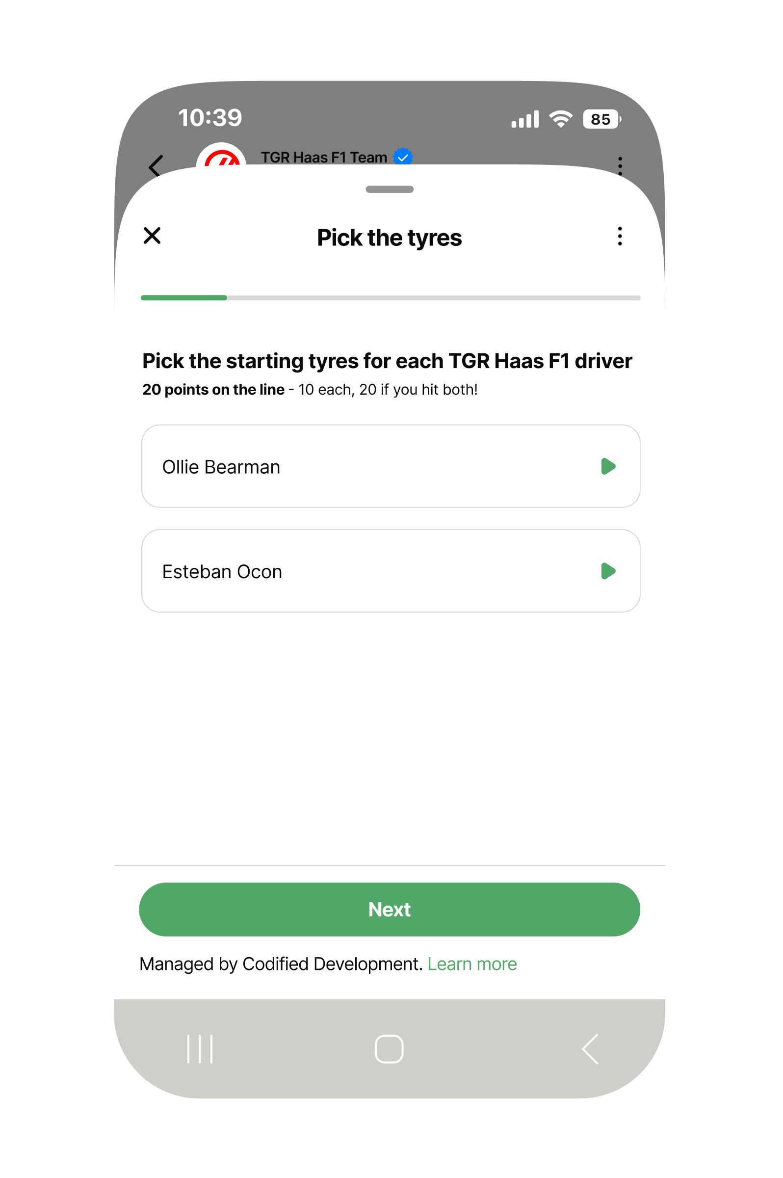 Mobile phone screen showing a WhatsApp-style quiz page titled ‘Pick the tyres.’ A progress bar near the top is partly filled. The question reads: ‘Pick the starting tyres for each TGR Haas F1 driver – 20 points on the line, 10 each, 20 if you hit both!’ Two selectable rows list the drivers’ names: ‘Ollie Bearman’ and ‘Esteban Ocon,’ each with a green arrow button on the right. At the bottom is a large green ‘Next’ button and a note saying the experience is managed by Codified Development.