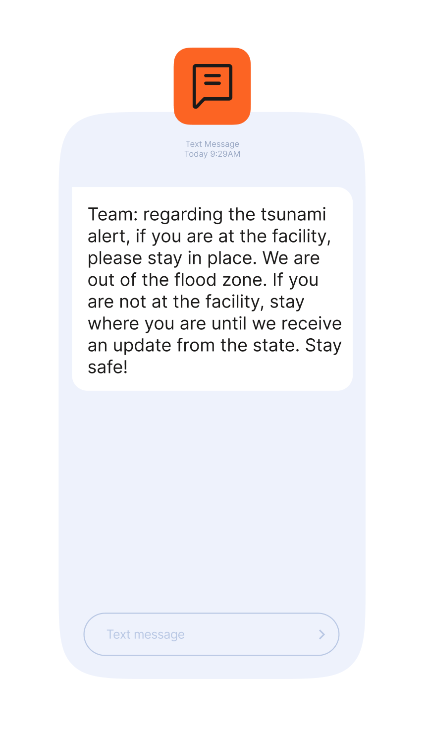 Illustration of a smartphone showing a text message alert. The message instructs recipients to stay in place due to a tsunami alert, advising those at a facility to remain there because it is outside the flood zone, and those elsewhere to stay where they are until further updates from the state. The message ends with ‘Stay safe!’ A text input field is shown at the bottom.