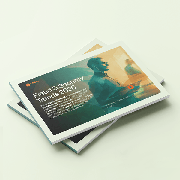 Two stacked report booklets on a light background, with the top cover showing an abstract illustration of a person holding a phone and the title “Fraud & Security Trends 2026” alongside Infobip branding.