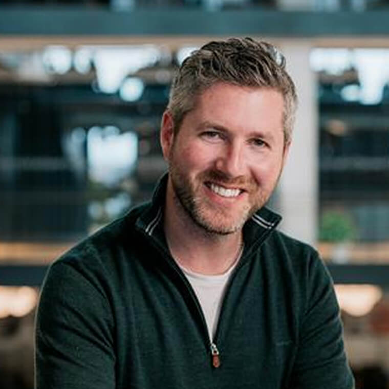 Ben Lewis VP of Marketing in Infobip smiling in an office setting, portrait photo