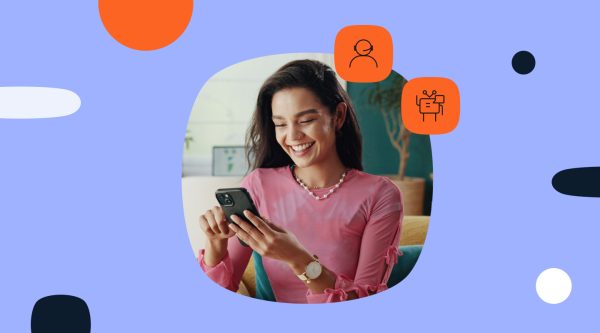 Smiling woman in a pink top looking at her phone, with customer support agent and chatbot icons on a light purple graphic background.